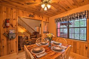 a dining room with a wooden table and chairs at Modern Cabin with Deck in the Blue Ridge Mountains! in Blairsville