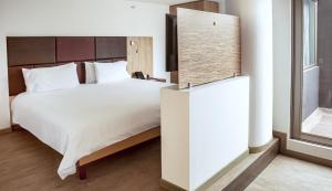 Postel nebo postele na pokoji v ubytování Hotel Viaggio Teleport City Suites
