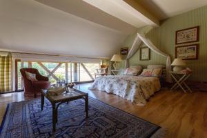 a bedroom with a bed and a table in a room at Ferme de la Haye in Montroty