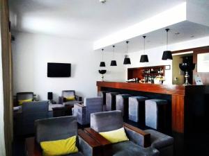 a waiting room with chairs and a bar at Hotel Acez in Vendas Novas