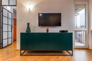 Televízia a/alebo spoločenská miestnosť v ubytovaní Apartments City Center Warsaw by Noclegi Renters