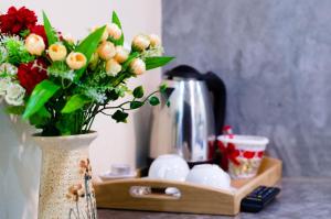 a vase with flowers in it sitting on a counter at The Sun Long Beach Resort in Ko Lanta