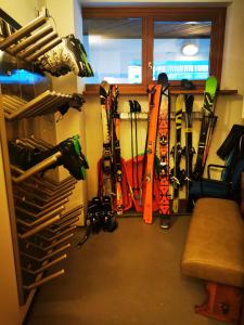 a room that has a bunch of skis in it at Residence Le Grand Chalet in Courmayeur