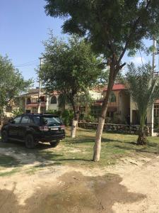a black suv parked in front of a house at Mufis Homestay, Emerald Compound, New Palam Vihar-2 in Gurgaon