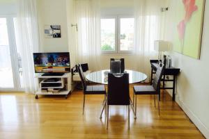 a dining room with a table and chairs and a television at Sabater in Altea