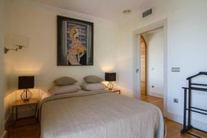 a bedroom with a large bed and two lamps at Sabater in Altea +27 photos