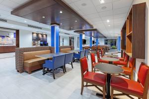 a dining room with tables and chairs in a restaurant at Holiday Inn Express & Suites - Tulsa Northeast - Owasso, an IHG Hotel in Owasso