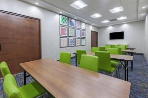 a conference room with tables and green chairs at Holiday Inn Express & Suites - Tulsa Northeast - Owasso by IHG in Owasso +43 photos