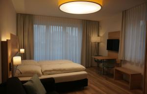 Postel nebo postele na pokoji v ubytování Leister Apparthotel