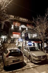 two cars parked in front of a gas station at night at Hotel Villa Gospava in Belgrade