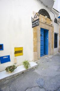 a building with a blue door and a sign on it at Dar Ya in Tunis