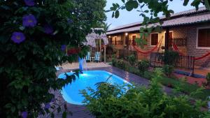 a swimming pool in front of a house at Pousada Brasil - São Miguel do Gostoso in São Miguel do Gostoso