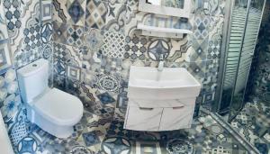 a bathroom with a toilet and a sink at Jordan Tower Hotel in Amman