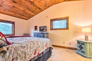 a bedroom with a bed and two windows at Mountain Cabin with Fire Pit, Walk to Golf and Fishing in Vilas