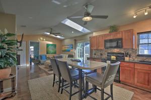 a kitchen and living room with a table and chairs at Beachy Palm Harbor Escape Swim Spa Pool and Gazebo in Palm Harbor