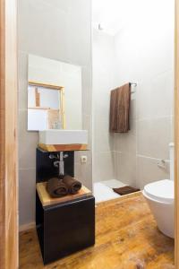 a bathroom with a sink and a toilet at Feel at Home Guest House in Ovar