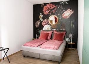 a bedroom with a bed with pink pillows and a mirror at Apartment 6 in Stockach