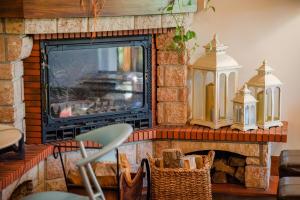 a living room with a fireplace with a tv at Usategieta in Oiartzun