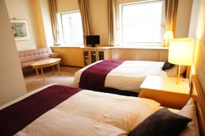 een hotelkamer met 2 bedden en een raam bij Hotel Abest Meguro / Vacation STAY 71406 in Tokyo