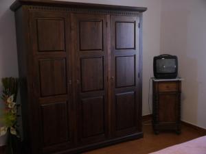 a large wooden cabinet with a tv in a room at Agriturismo Le Stiacce in Saturnia