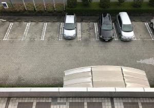 an overhead view of cars parked in a parking lot at Ogaki Forum Hotel / Vacation STAY 72181 in Ogaki +8 photos