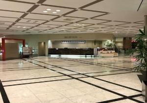 an empty lobby with a mall with a check in counter at Ogaki Forum Hotel / Vacation STAY 72181 in Ogaki