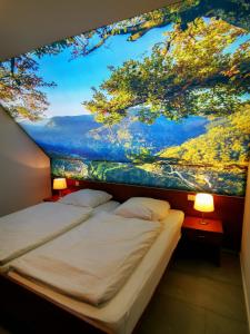 a bedroom with a large painting on the wall at Park Appartements in Badenweiler