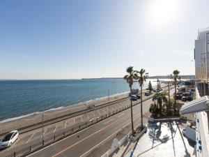 a road next to the beach with palm trees at Mykonos Resort Miura / Vacation STAY 72794 in Yokosuka