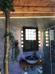 a bathroom with a sink and a tree in it at Halkidiki Trikorfo Luxury Maisonette in Gerakini