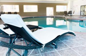 a wicker chair sitting next to a swimming pool at Quality Inn Vernal near Dinosaur National Monument in Vernal