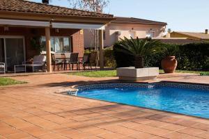 a swimming pool in front of a house at Casa Bella con piscina in Caldes de Montbui