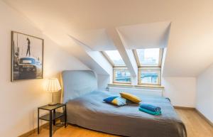 a bedroom with a bed and two pillows on it at Central 2-level Penthouse with Terrace and free parking in Riga