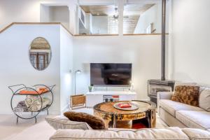 a living room with a couch and a table at Skyline Serenity in South Lake Tahoe