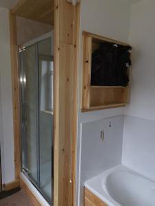 a bathroom with a shower and a tub and a sink at The Comfy House in Huddersfield
