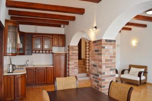 a kitchen with a table and a brick wall at Apartments 4 in the historic part of Znojmo in Znojmo