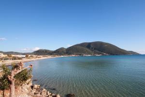 a view of a beach with a mountain in the background at Romanza Studios in Vasiliki