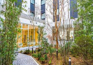 a garden in front of a building at Bande Hotel Tenpozan Higashi in Osaka