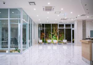 an empty lobby with chairs and tables in a building at Bande Hotel Tenpozan Higashi in Osaka