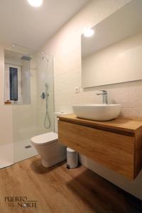 a bathroom with a sink and a toilet at Apartamentos Puerto Norte - Apto 1 in Puerto de Vega