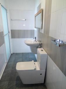 a bathroom with a toilet and a sink at Shanthi Guest & beach villa in Ambalangoda