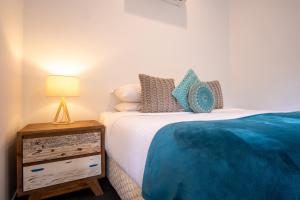 a bedroom with a bed and a lamp at Kondalilla Eco Resort in Montville