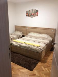 two twin beds in a room with a door at Majestic Rooms&Apartments in Prilep