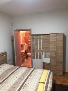 a bedroom with a large bed and a bathroom at Majestic Rooms&Apartments in Prilep