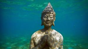 a statue of a woman in the water at Alegria Dive Resort in Alegria