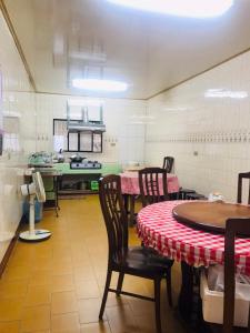 a kitchen with a table and chairs in a room at Riley Ming Xuan B&B in Meishan