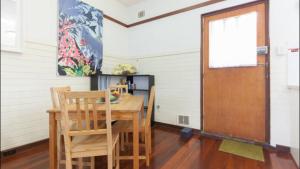 a dining room with a wooden table and chairs at B4 Crawley Apartment 1 BRM & Sleepout near UWA in Perth