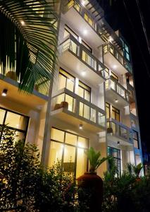 a large white building with many windows at night at Luxx Boutique Boracay in Boracay