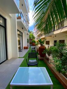 a ping pong table in the courtyard of a building at Luxx Boutique Boracay in Boracay