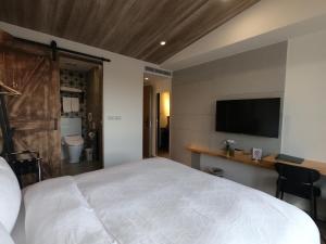 Postel nebo postele na pokoji v ubytování Watermark Hotel Kaohsiung Main Station