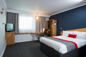 a hotel room with a bed and a desk at Holiday Inn Express Derby Pride Park, an IHG Hotel in Derby